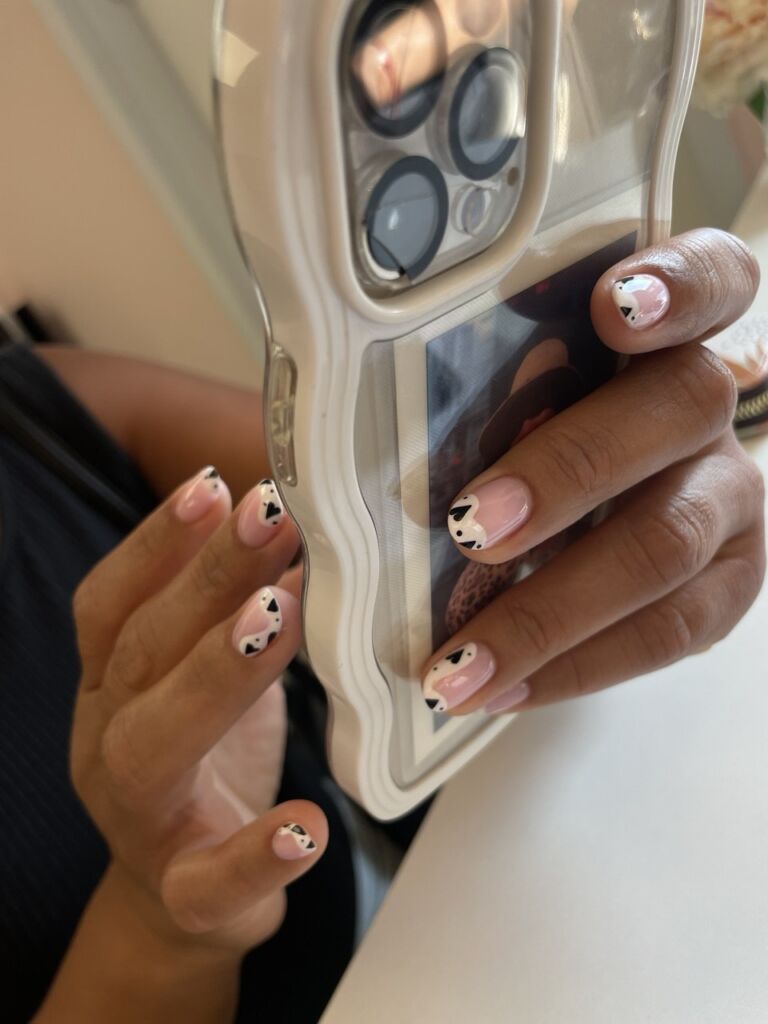 Heart-shaped dreams. Soft nude base with delicate black and white heart accents: romantic, playful, and perfectly sweet.