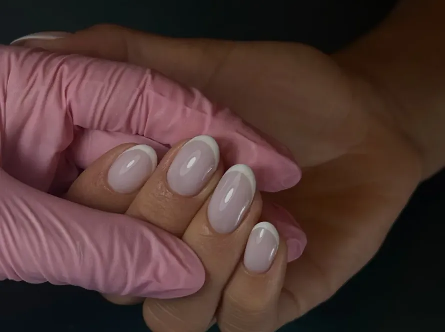 Close-up of long square-shaped nails with a clean opaque white high-gloss gel finish, representing a sleek modern bridal manicure option for Queens and NYC brides at Midlton Nails Studio.